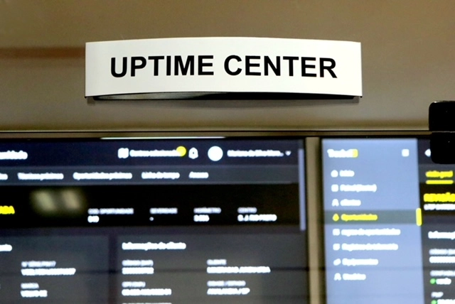 Placa Uptime Center sobre os monitores